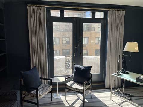 Double doors overlooking a city balcony